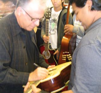 The Romeros autograph student guitars after the Fall 2006 Master Class at Mt. Pleasant High School